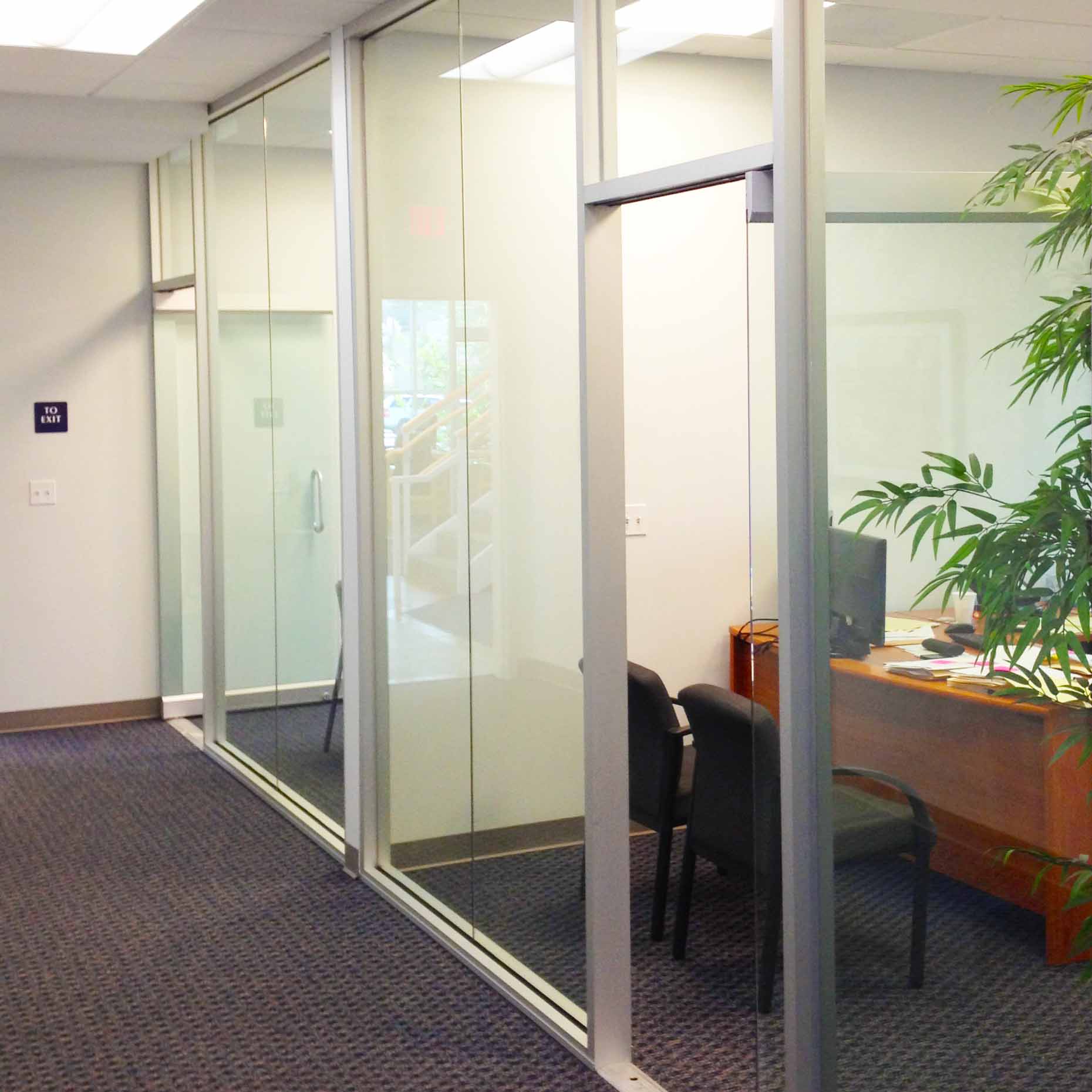 Offices separated by clear glass panels makes the floor look more spacious.