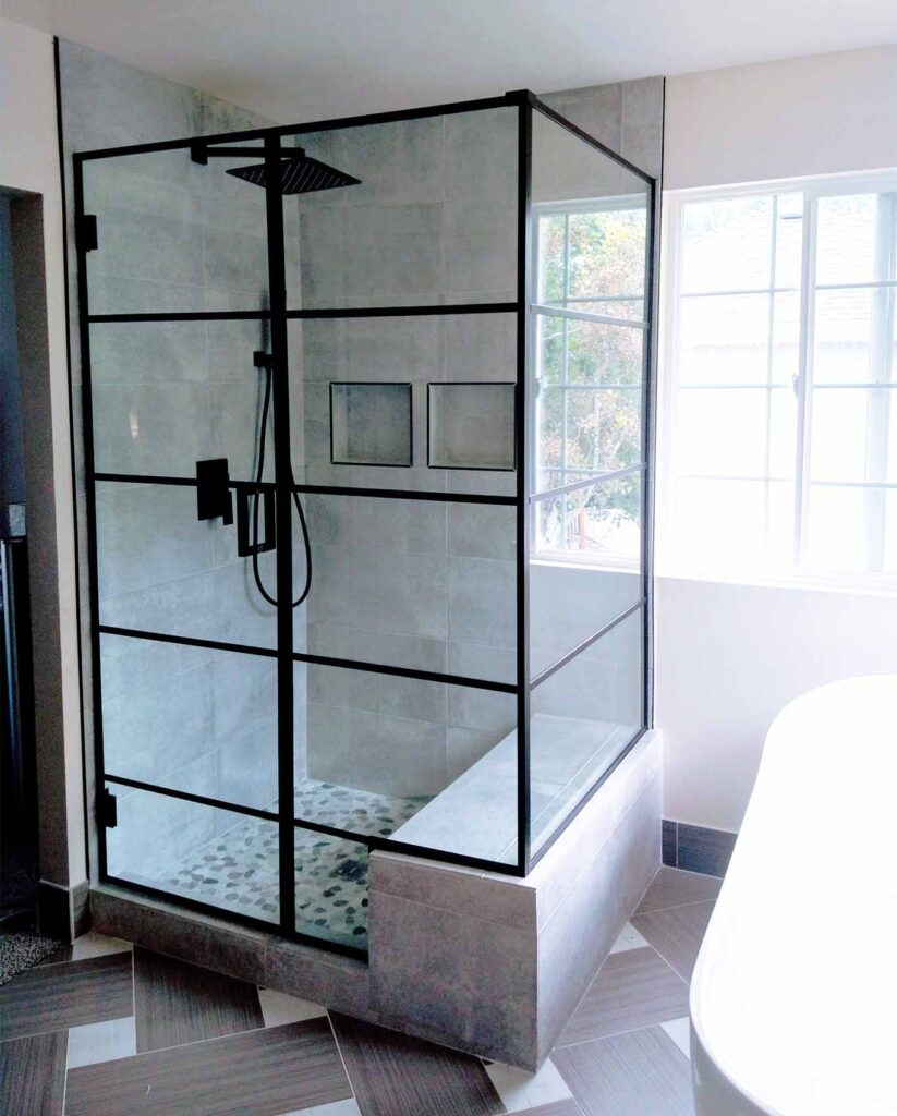 A modern looking glass shower with multiple clear glass panels.