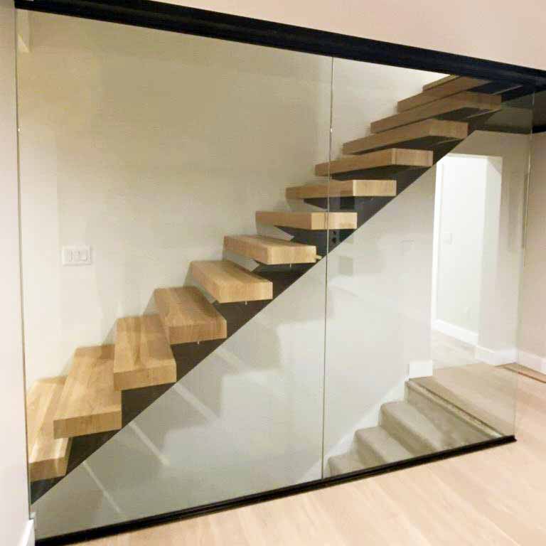 a floor to ceiling glass railing, looks clean and sophisticated.