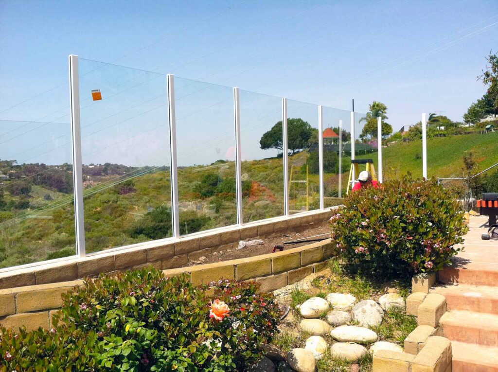 Outdoor glass railing enclosing a big yard