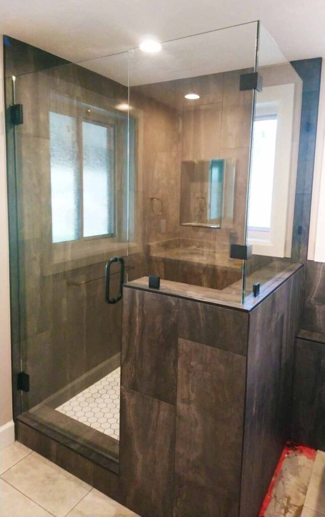 Corner shower enclosed with glass.