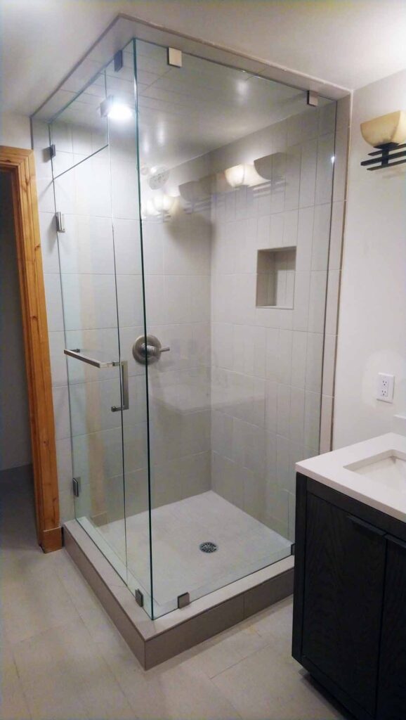 Clean glass enclosed shower in a simplistic bathroom.