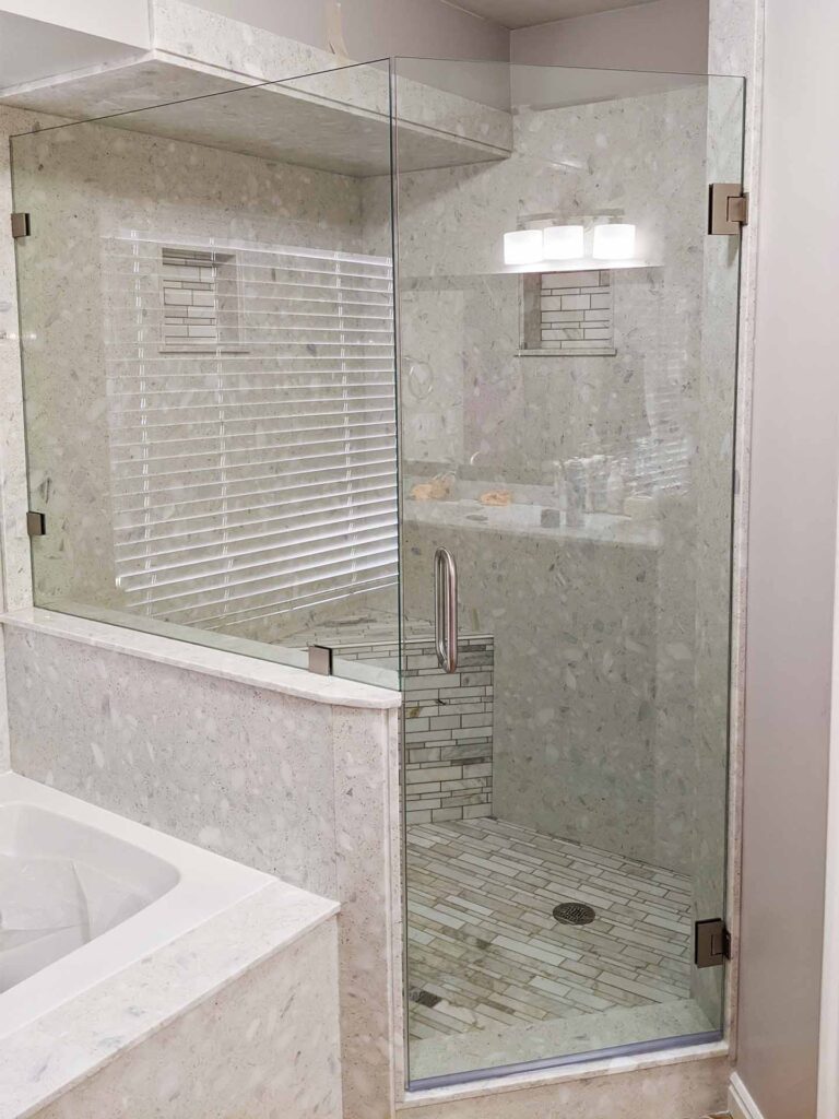 Shower with half wall half glass window and frameless enclosure.
