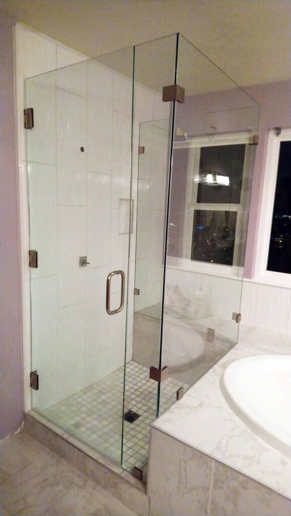 Simple and modern bathroom design with frameless glass shower divider.
