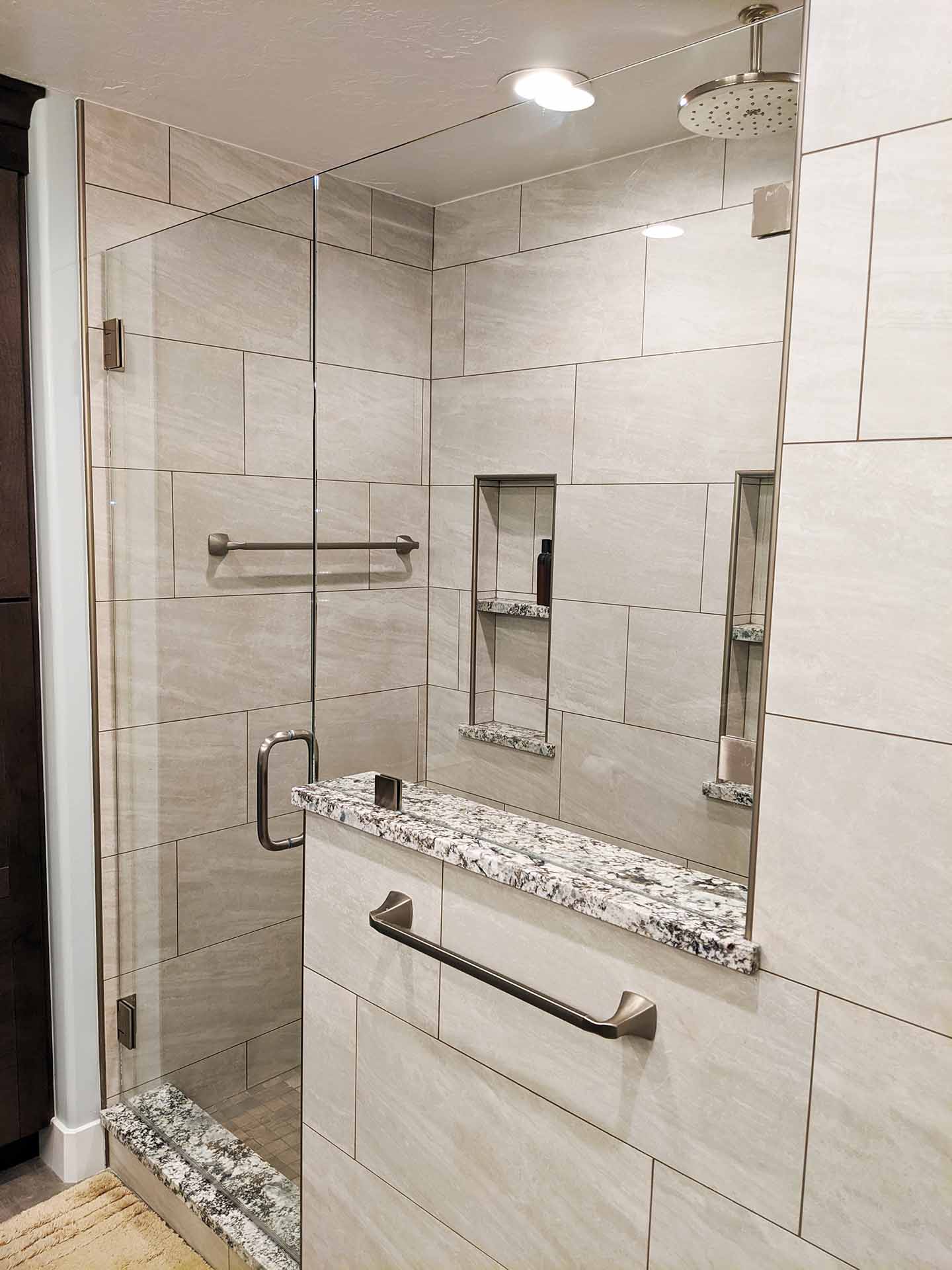 Roman-Greek style bathroom with frameless glass shower.
